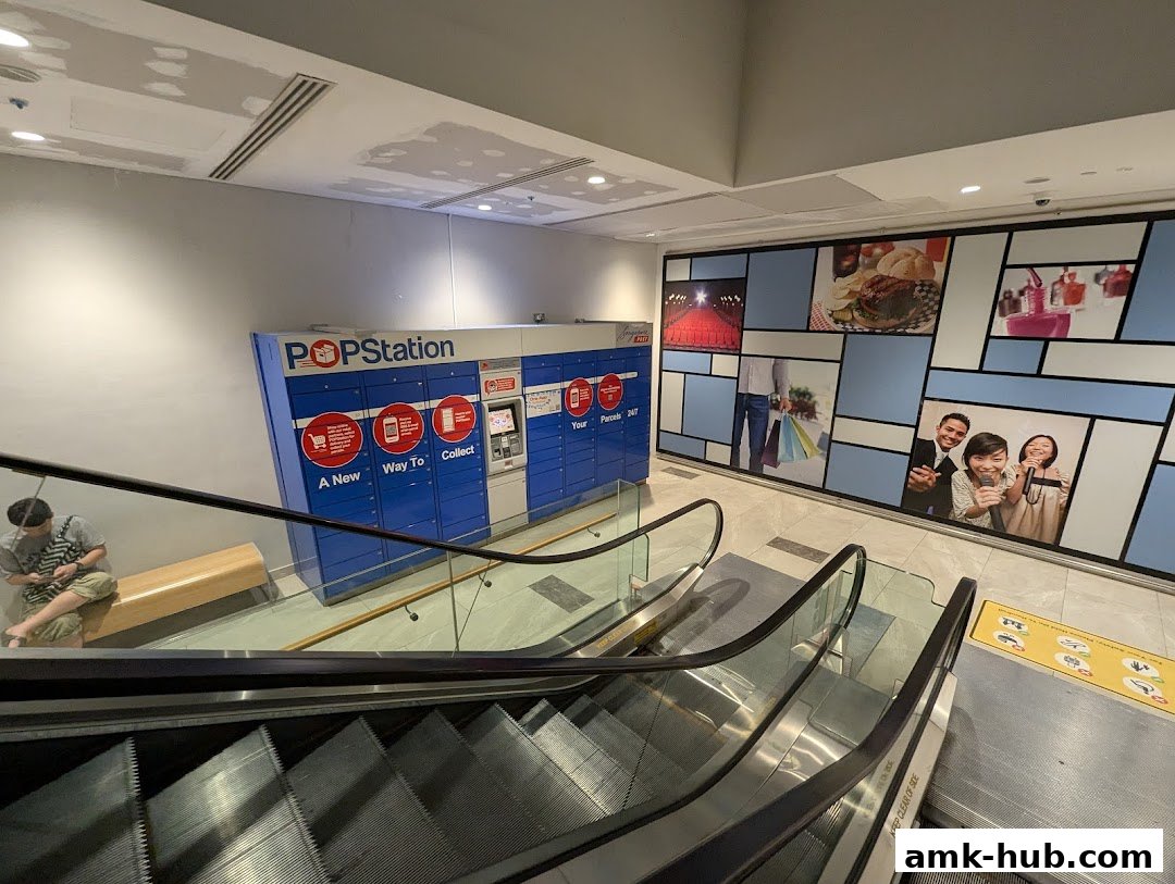 POPStation parcel lockers are located near escalators with a decorative wall featuring lifestyle images.