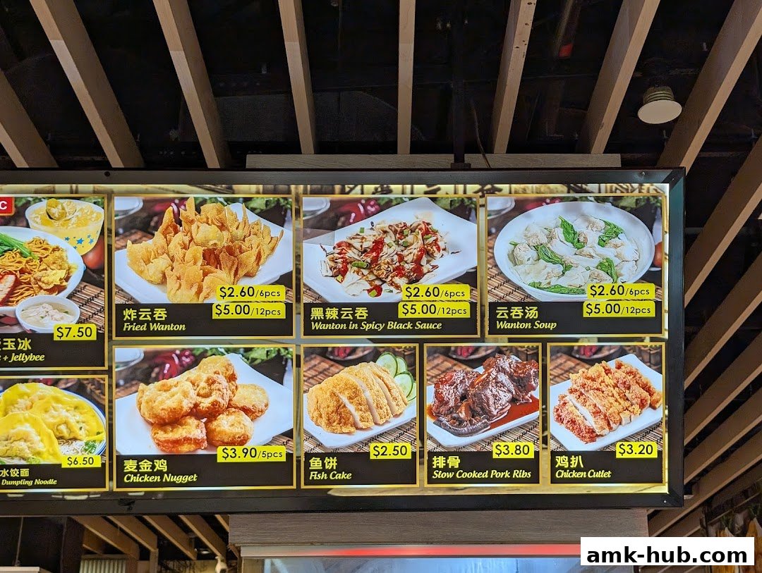 A brightly lit menu board displaying various noodle and side dishes from Pontian Wanton Noodle.