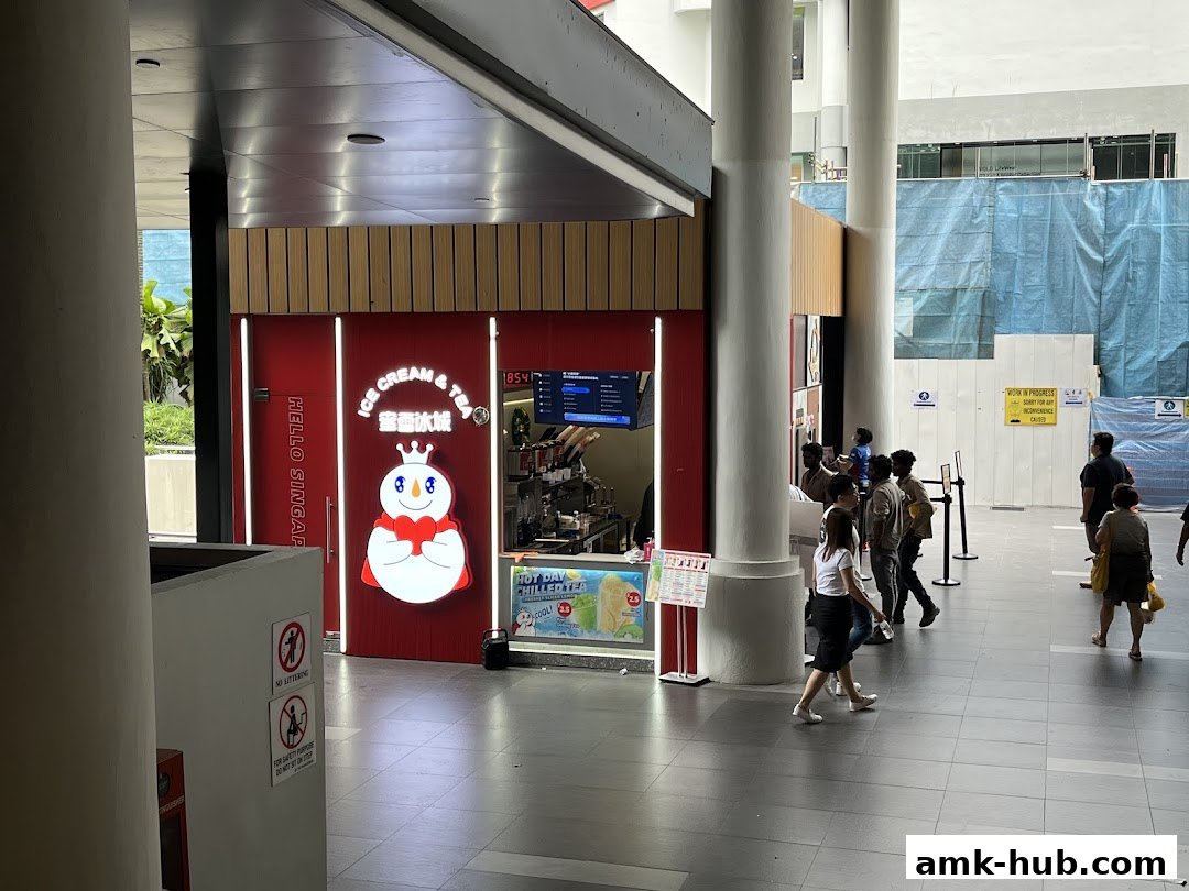 A MIXUE Ice Cream & Tea shop with its signature snowman logo and people walking by.
