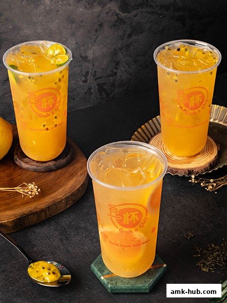 Three refreshing fruit teas with passion fruit and citrus slices, presented in clear cups.