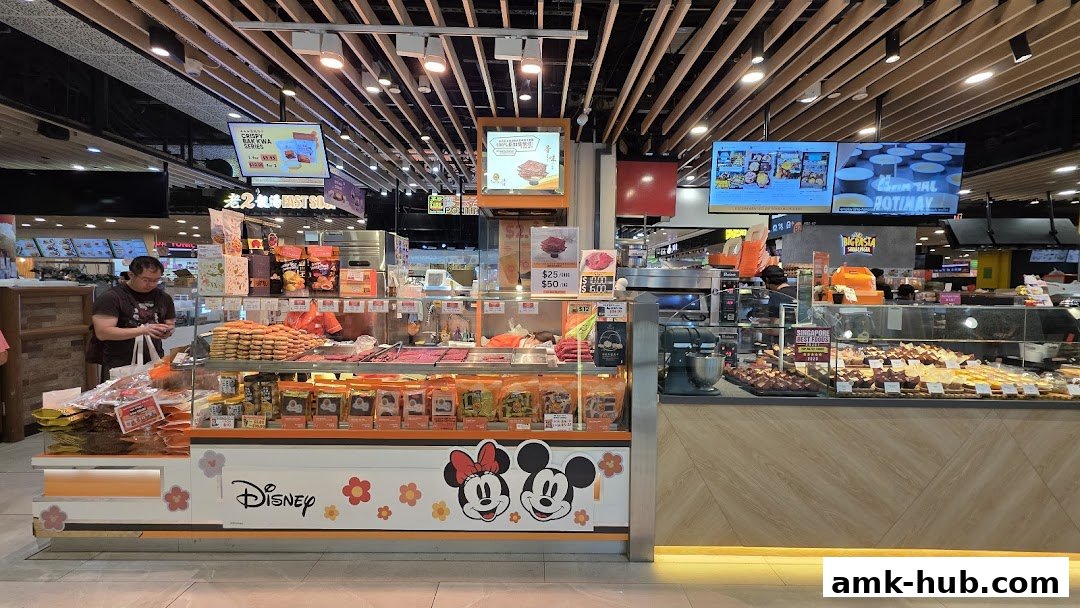 A retail shop display featuring various food items, including bak kwa and pastries, with Disney characters.