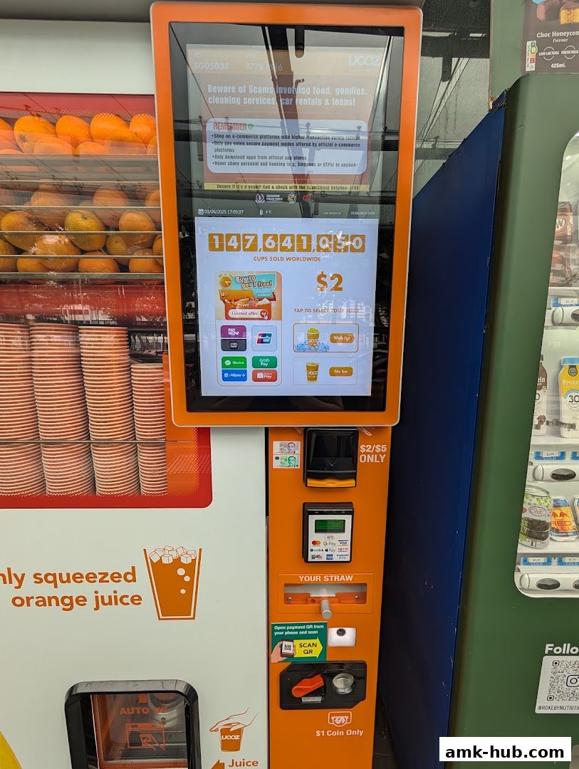 An iJooz juice vending machine displaying cups sold worldwide and payment options.