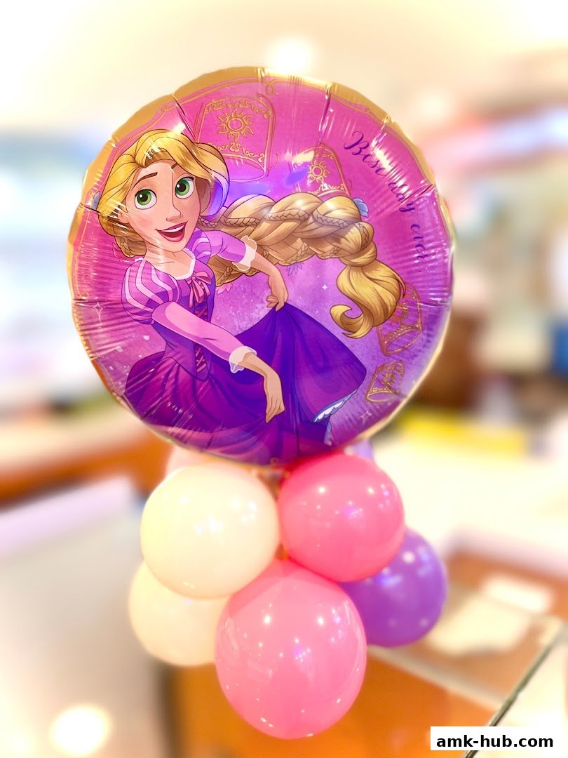 A Rapunzel-themed balloon bouquet with pink and purple balloons.
