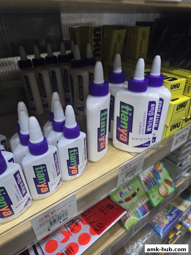 Shelves stocked with white glue bottles and art supplies like colored pencils and books.