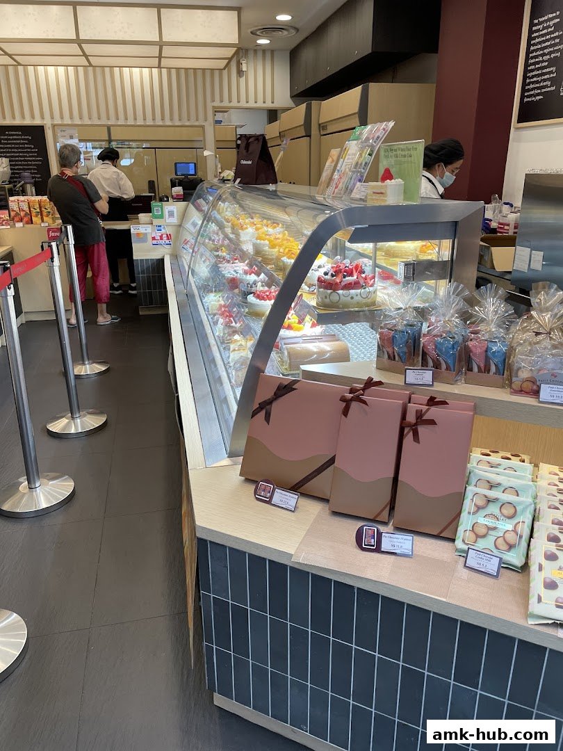 Interior of a Châteraisé bakery with a display of cakes and packaged sweets.