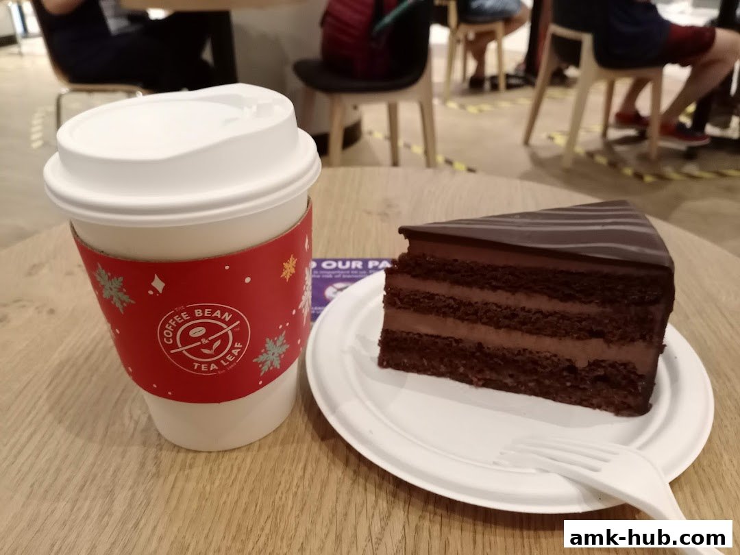 A slice of chocolate cake and a coffee cup from The Coffee Bean and Tea Leaf.