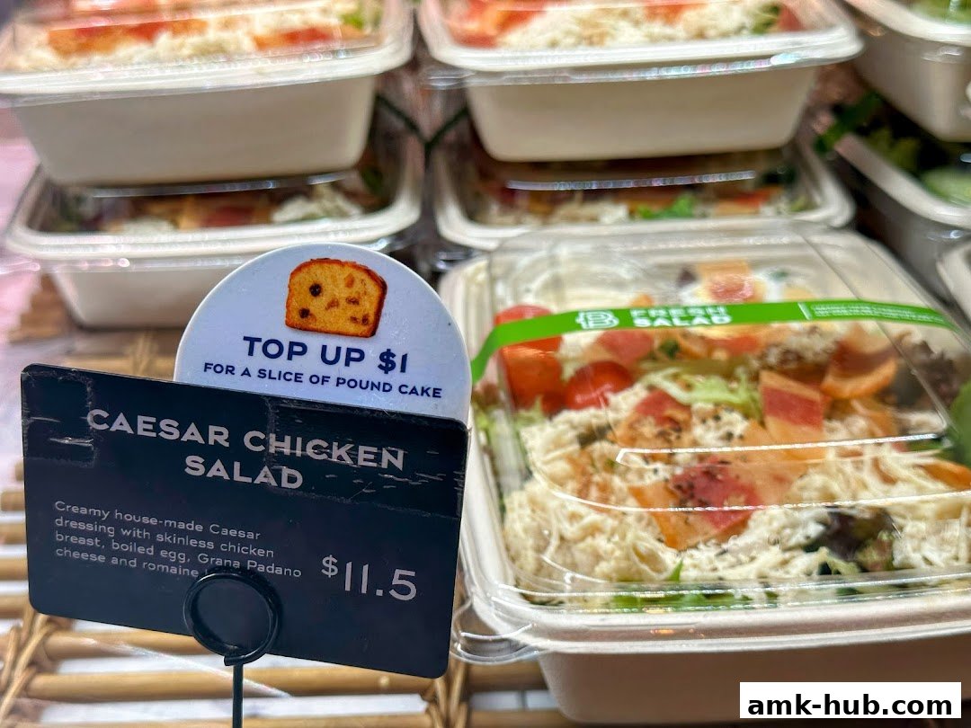 A close-up of a Caesar Chicken Salad with a sign offering pound cake.