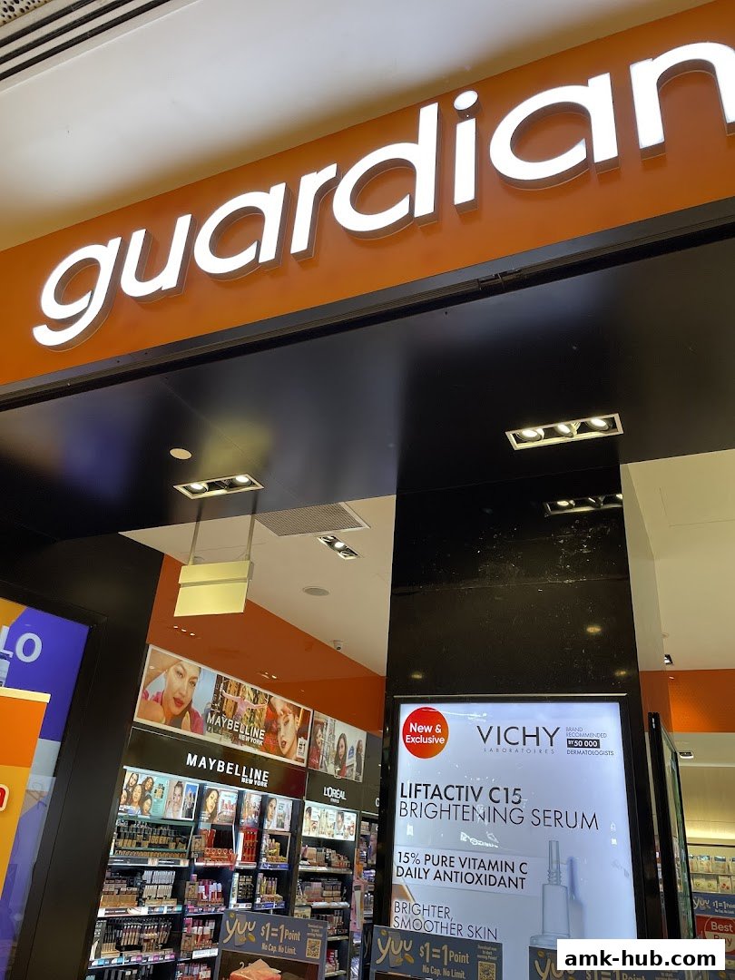 The entrance of a Guardian Health & Beauty store, featuring prominent signage and product displays.