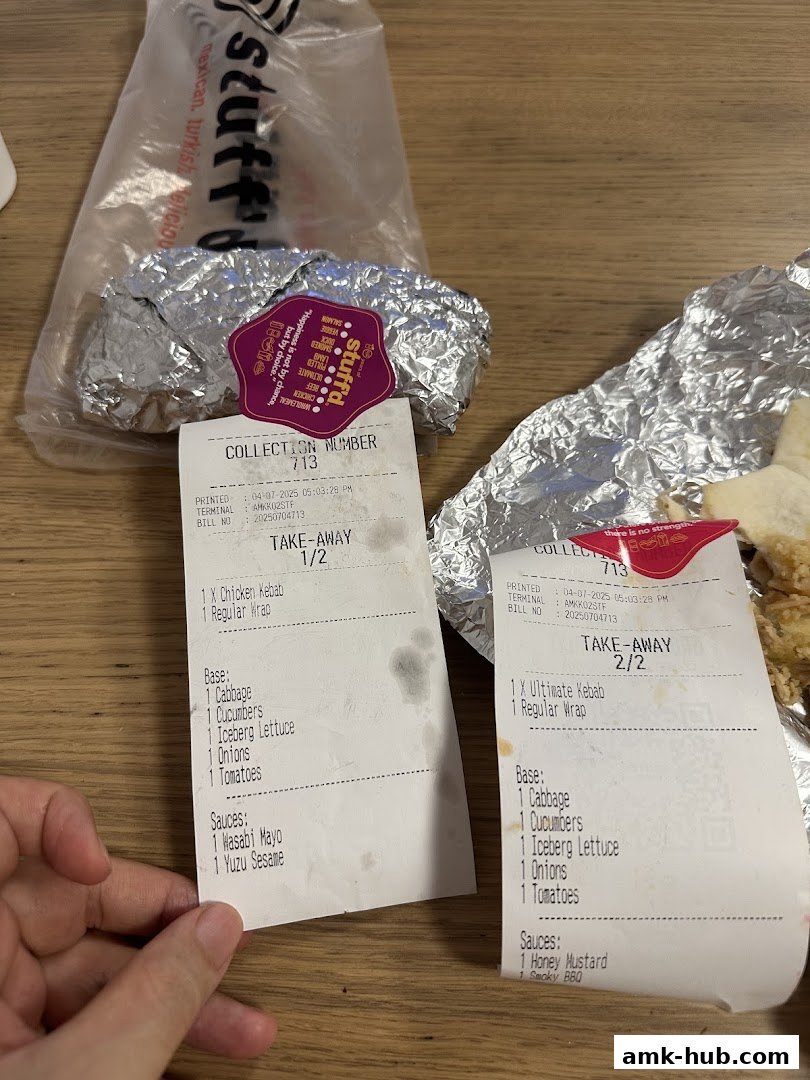 Two takeaway receipts and foil-wrapped food items from Stuffd More.