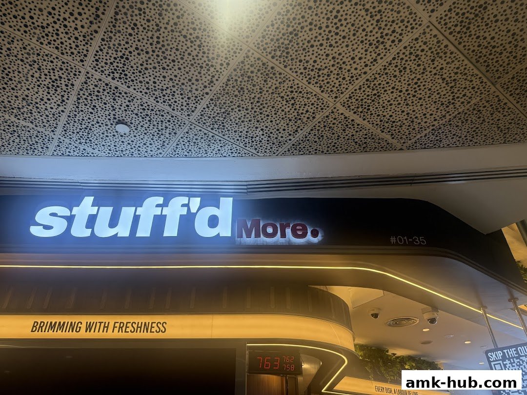 The illuminated sign for 'Stuff'd More' with the slogan 'Brimming with Freshness'.