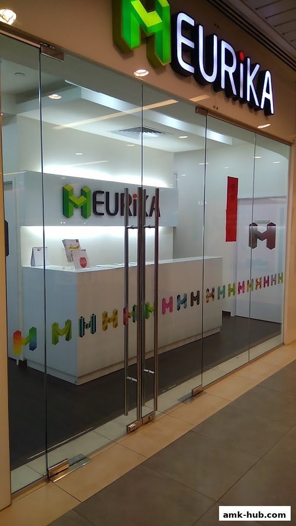 The entrance to Heurika Institute of Mathematics, a modern educational center with glass doors and a clean interior.