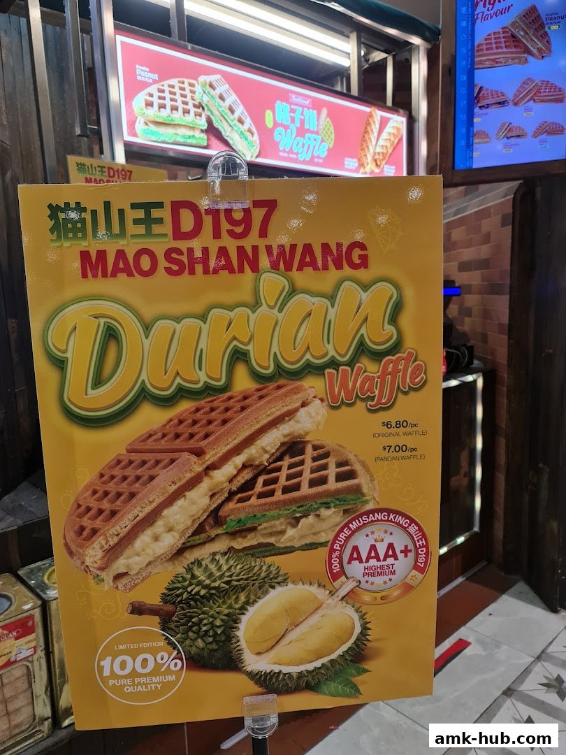 A sign advertising Mao Shan Wang Durian Waffles with prices and images of the product.