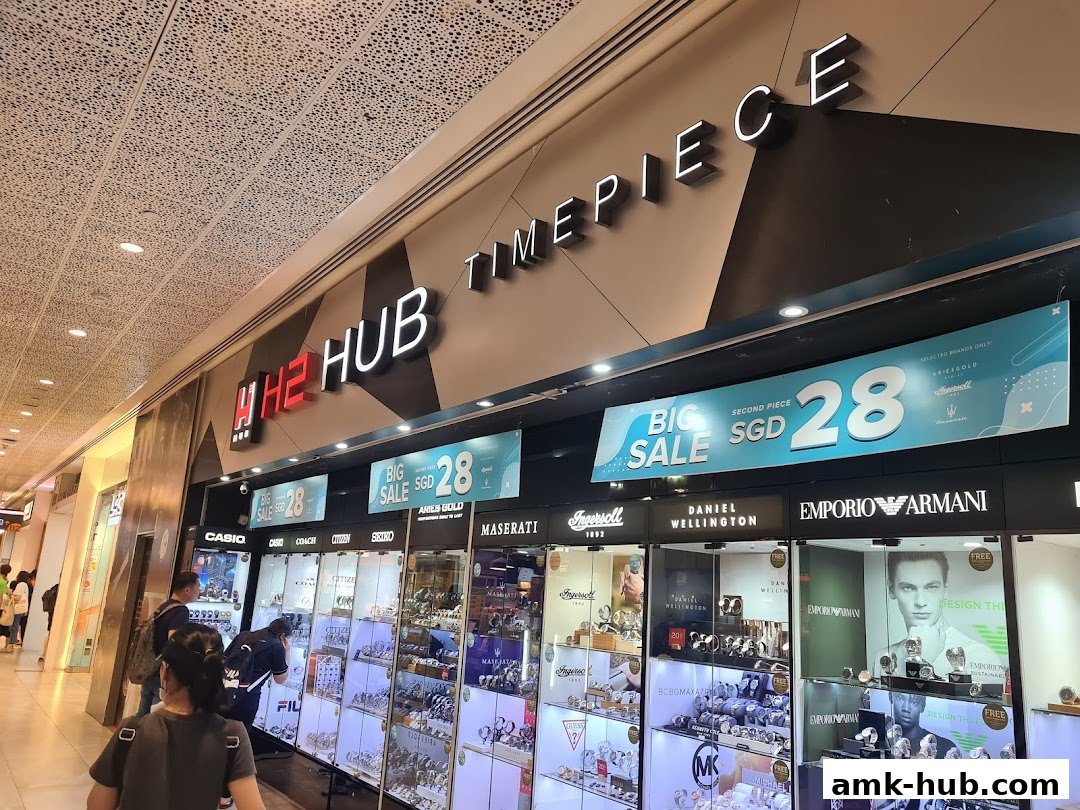 The exterior of a H2 Hub Timepiece shop showcasing various watch brands and a big sale banner.