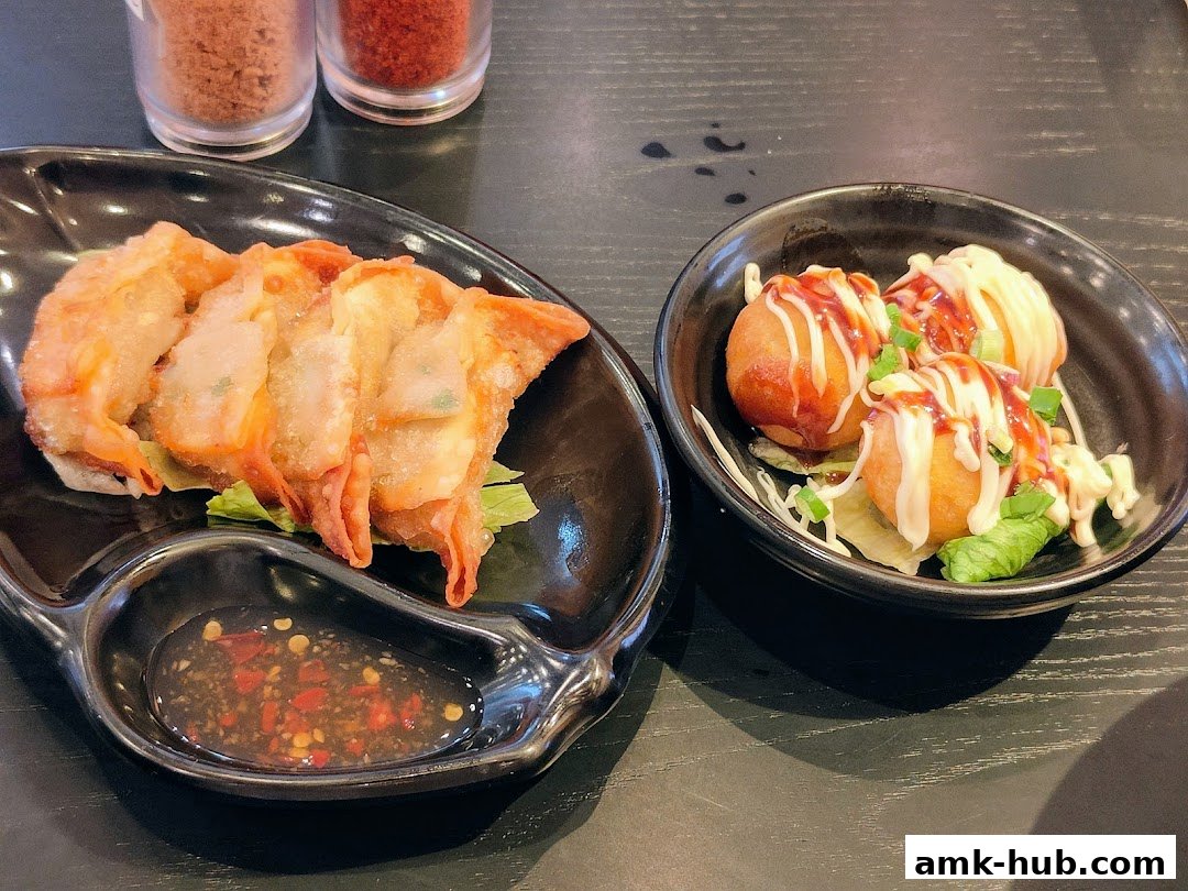 Two plates of Japanese appetizers, one with fried dumplings and dipping sauce, the other with takoyaki.