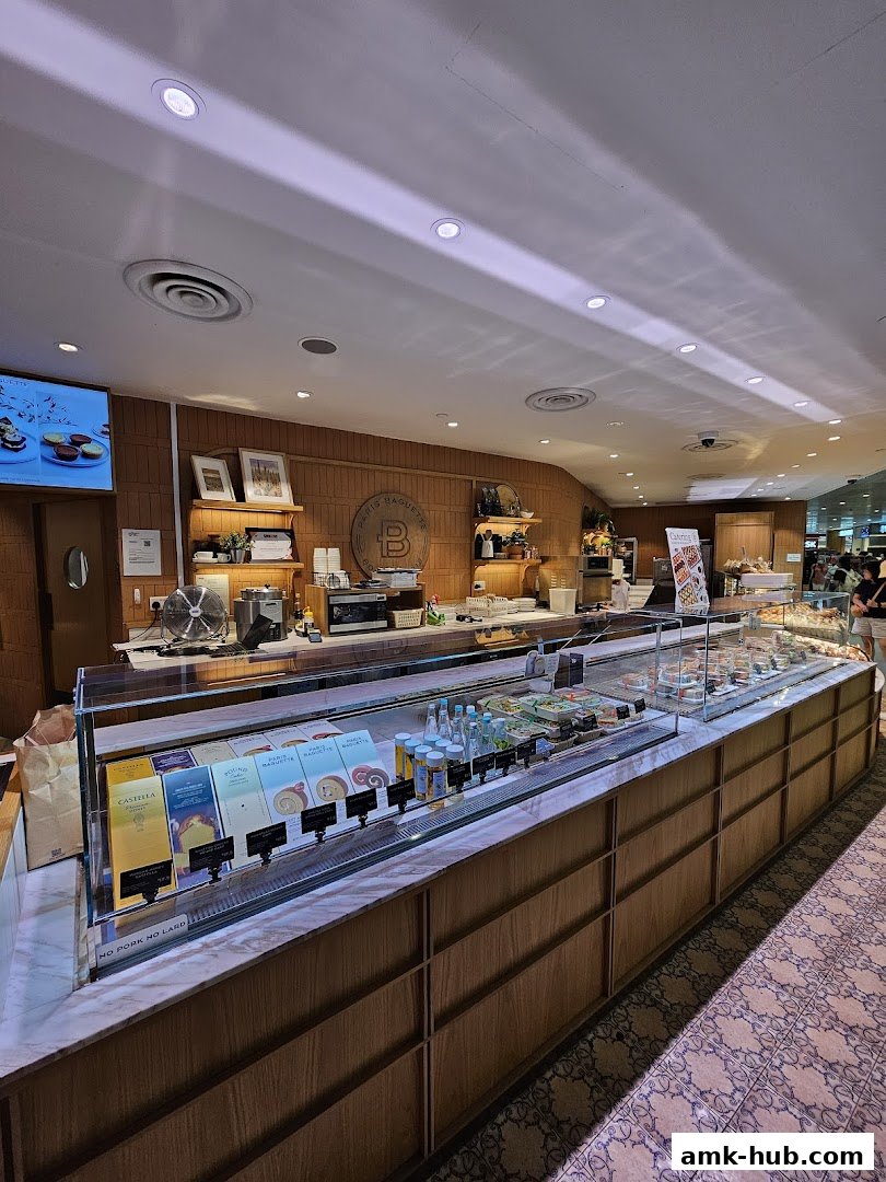 Interior view of Paris Baguette AMK Hub showcasing a display of cakes, pastries, and drinks.