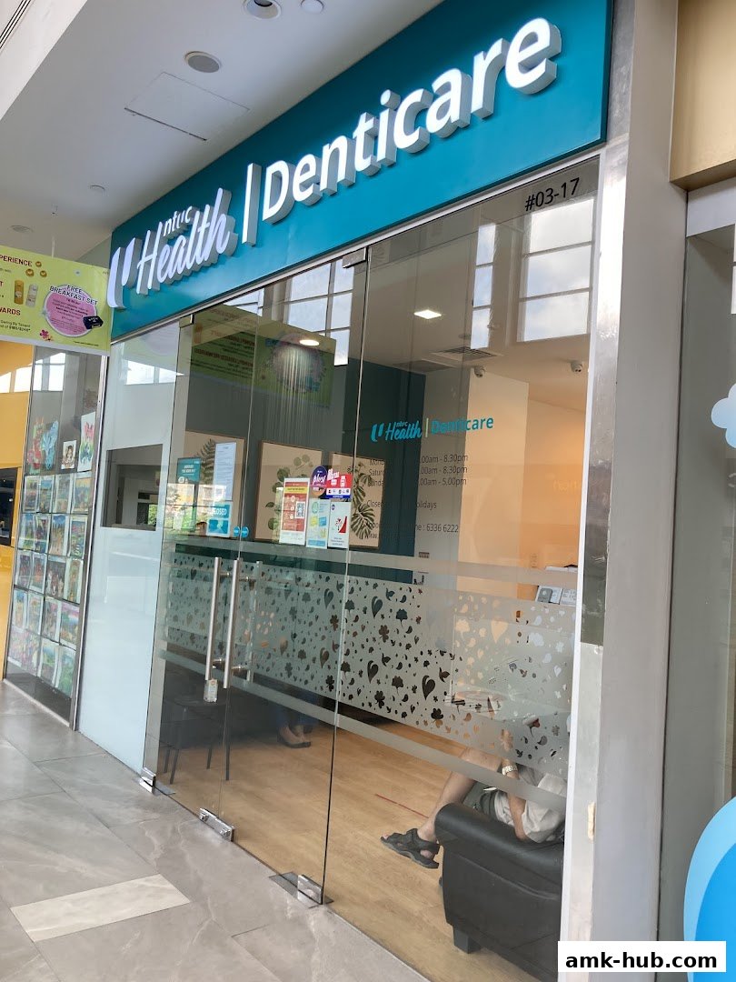 The entrance of Denticare, a dental clinic, with its name displayed prominently on the facade.