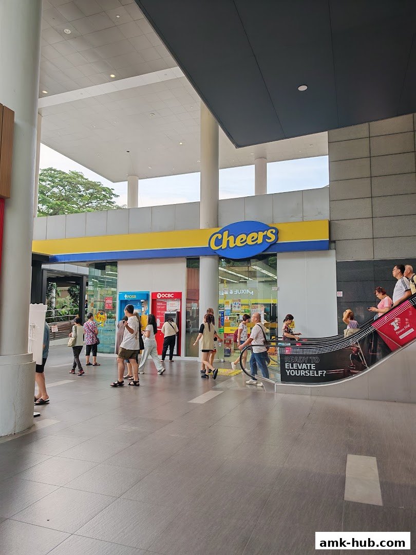 The exterior of a Cheers convenience store with people walking by and an escalator.