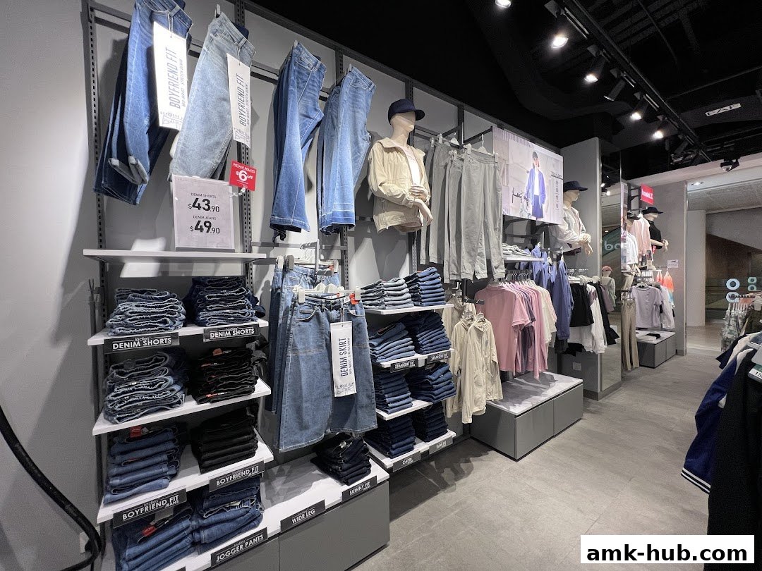 Interior view of a clothing store displaying jeans, shorts, and other apparel on shelves and racks.