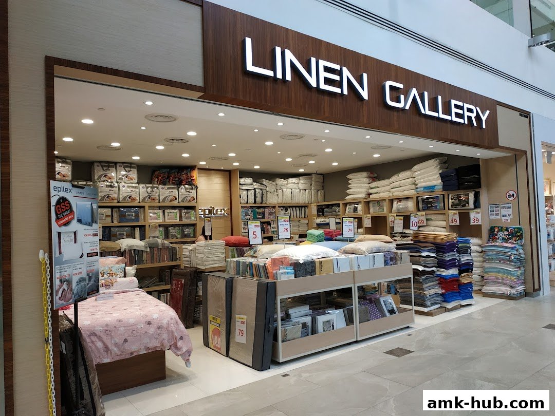 The exterior of a bedding and home goods store, Linen Gallery, showcasing various products.