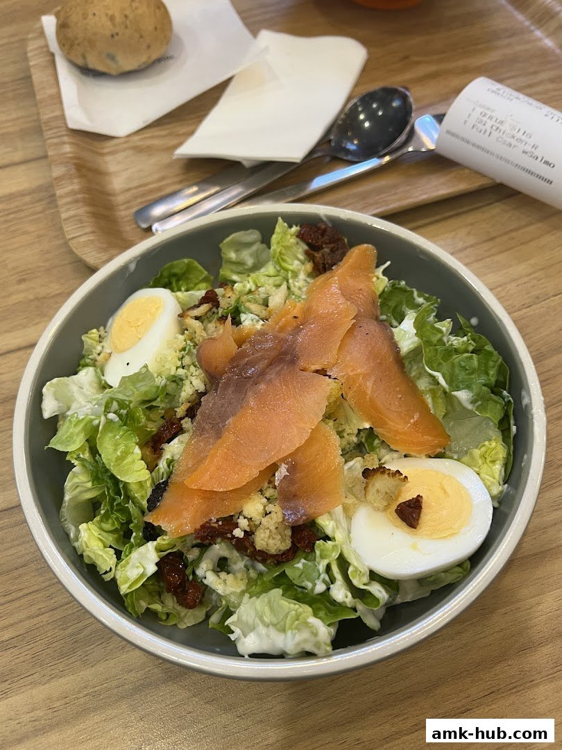 A delicious salmon salad with eggs and sun-dried tomatoes served in a bowl.