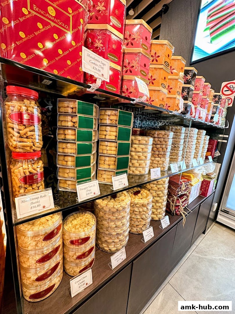 A display of assorted cookies and snacks in decorative tins and jars at Bengawan Solo.