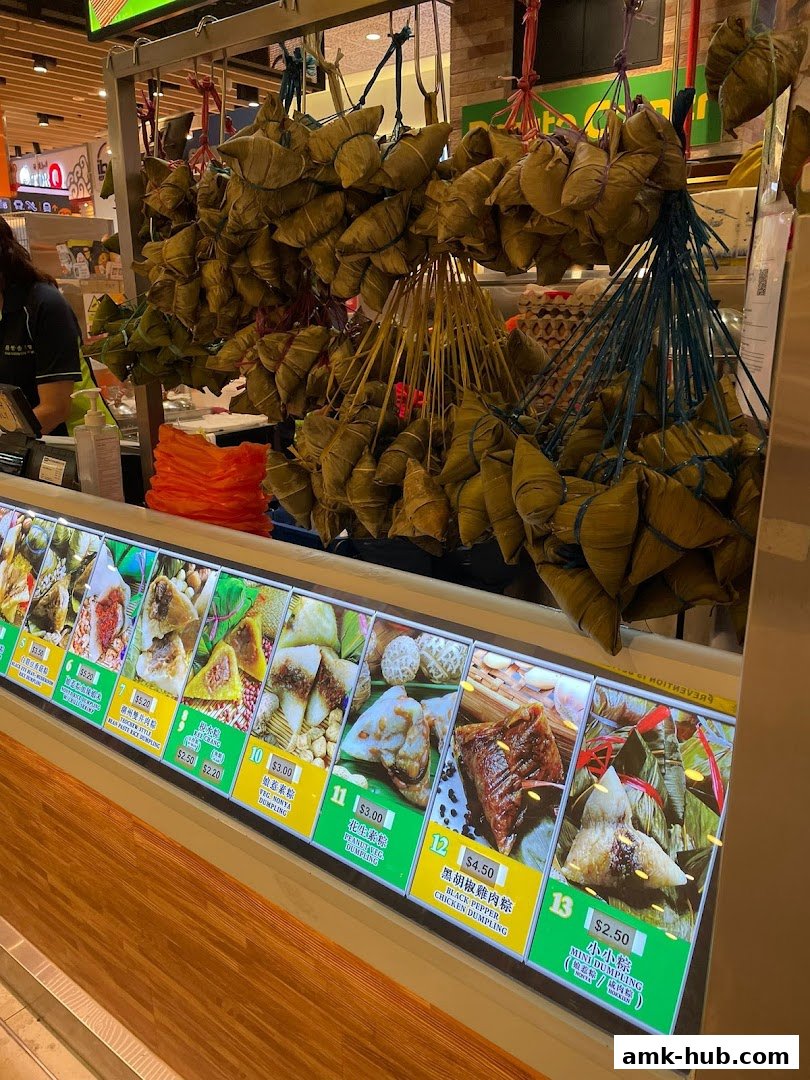 A display of various rice dumplings with pictures and prices.