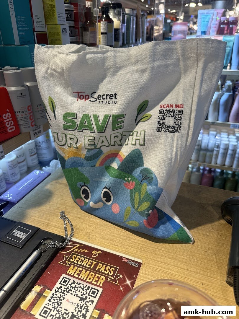 A tote bag with 'Save Our Earth' slogan and a QR code on a counter.