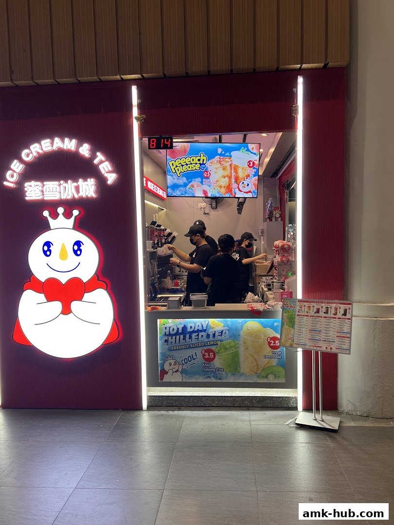 A Mixue Ice Cream & Tea shop with staff preparing drinks and promotional displays.