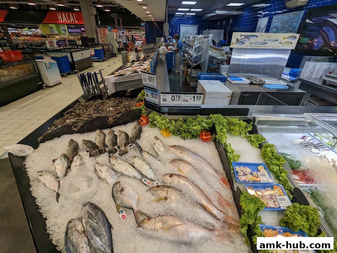 A wide selection of fresh fish and seafood displayed on ice at a supermarket counter.