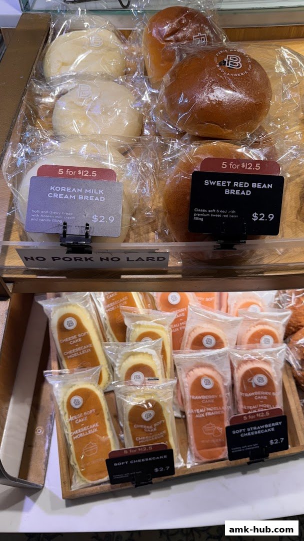 A display of individually packaged breads and soft cheesecakes from Paris Baguette.