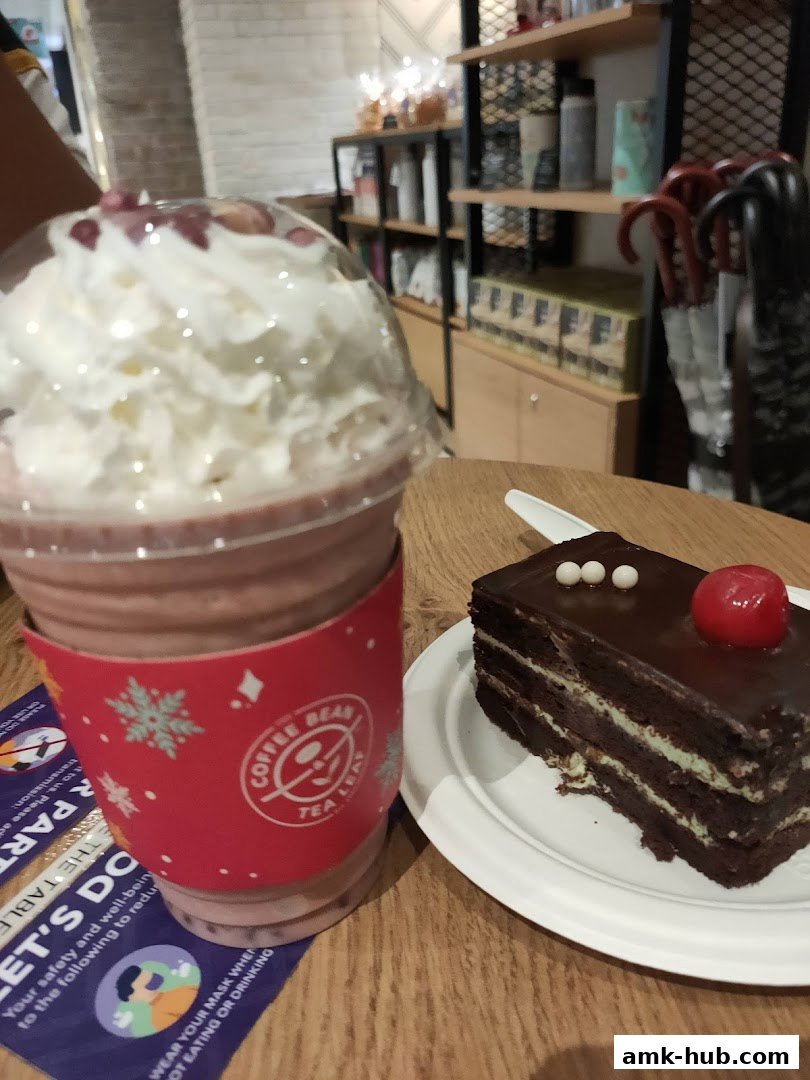 A chocolate cake and a beverage with whipped cream and toppings at The Coffee Bean and Tea Leaf.