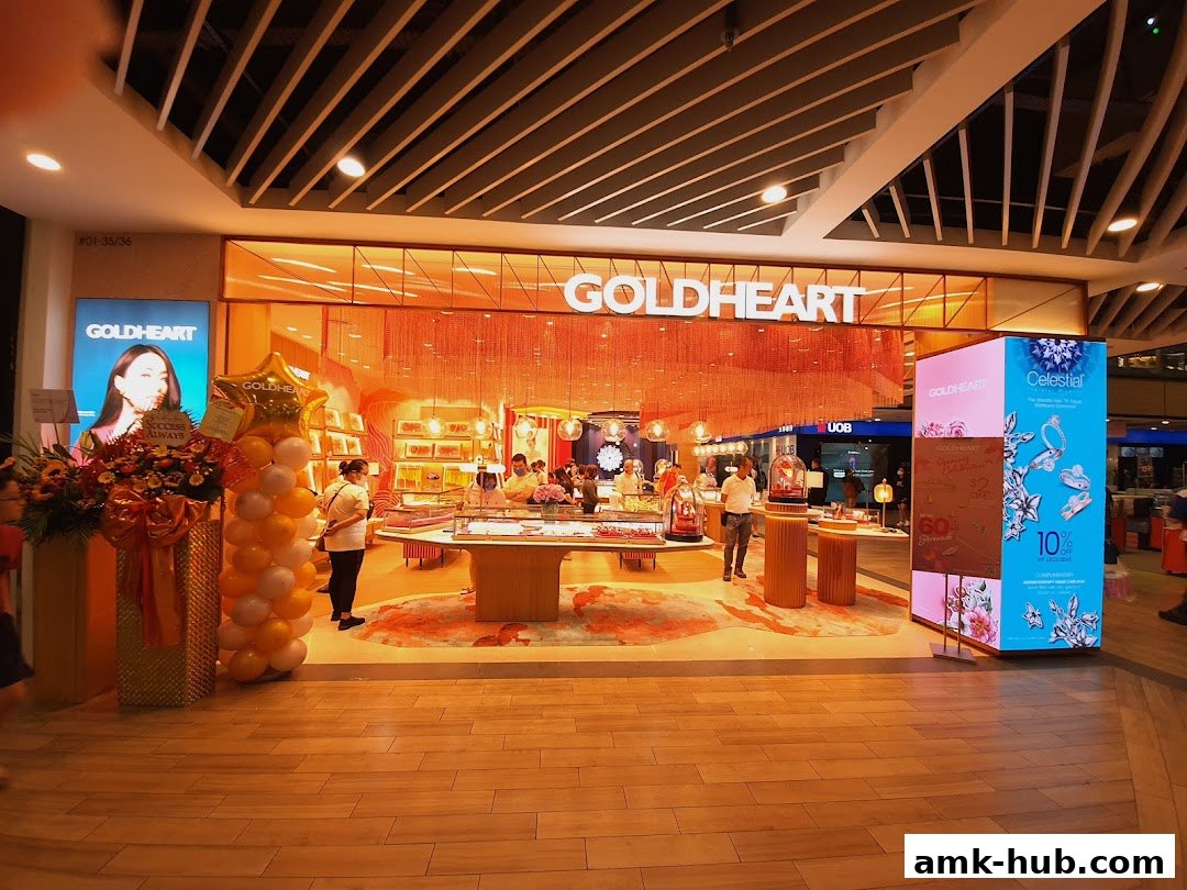 Goldheart Jewelry store entrance with displays, balloons, and promotional signage.