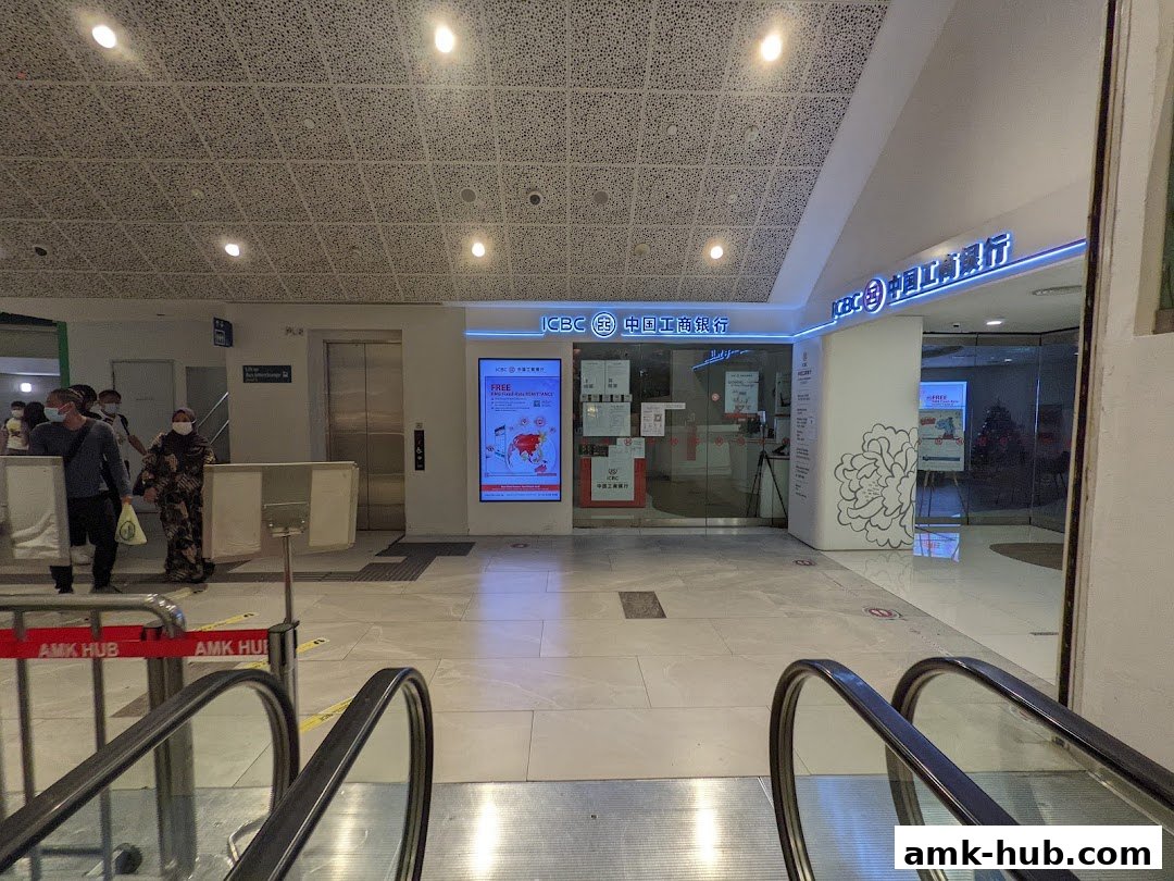 The entrance to the ICBC Ang Mo Kio Sub-Branch bank with signage and an advertisement.