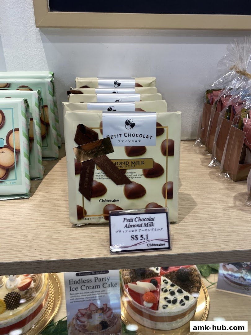 Châteraisé shop display featuring Petit Chocolat Almond Milk and various cakes.