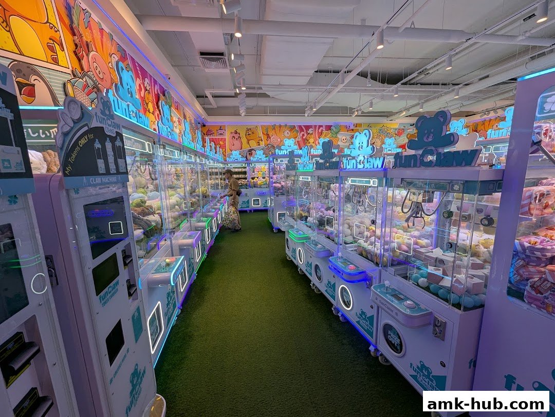 Interior of a brightly lit arcade with rows of colorful claw machines filled with plush toys.