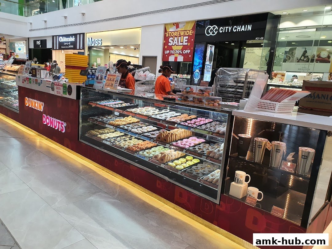 A Dunkin' Donuts shop counter filled with a variety of colorful donuts and pastries.