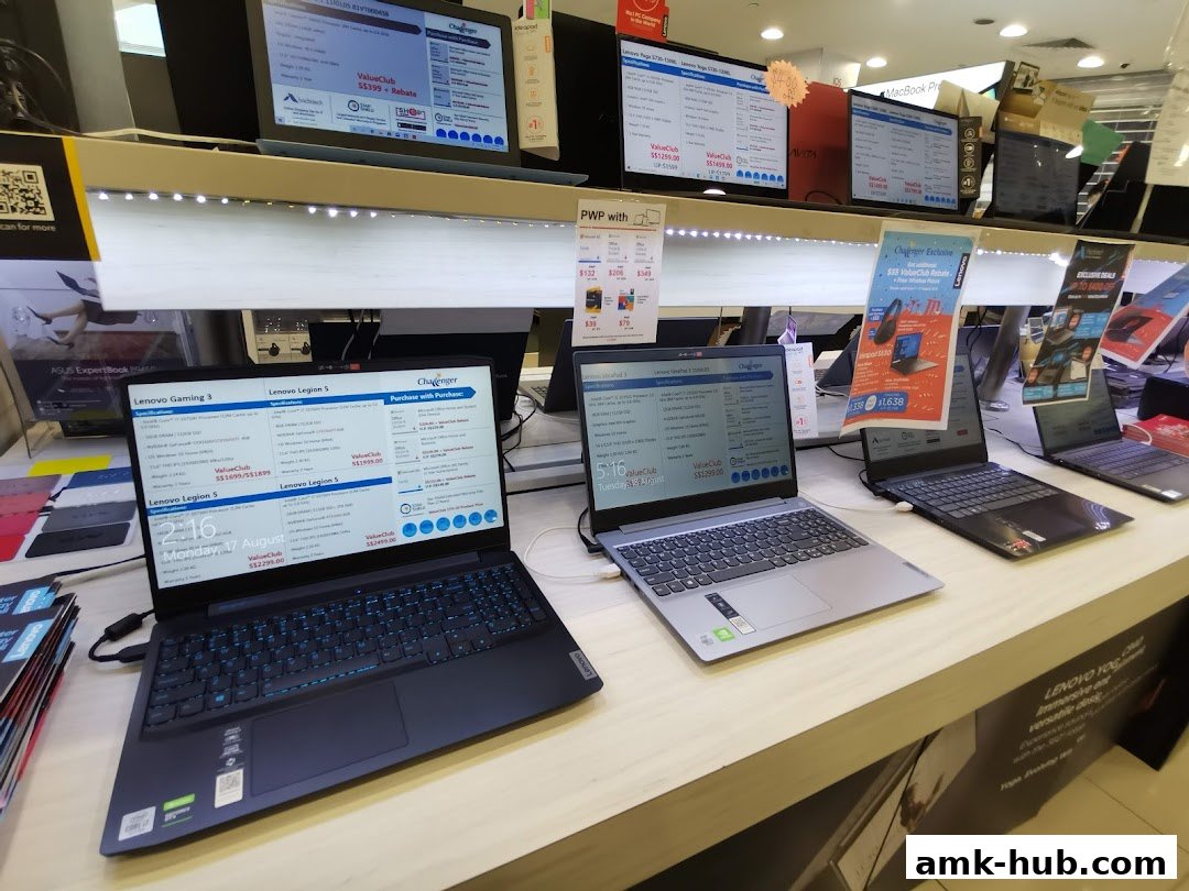 A display of various Lenovo laptops with specifications and pricing information.