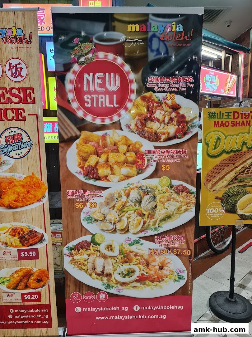 A promotional banner showcasing various Malaysian dishes and a durian waffle.