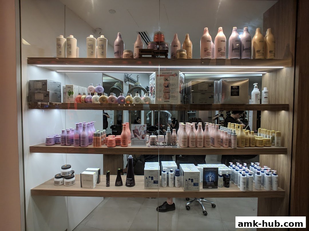 Shelves stocked with various hair care products, including shampoos, conditioners, and styling treatments.