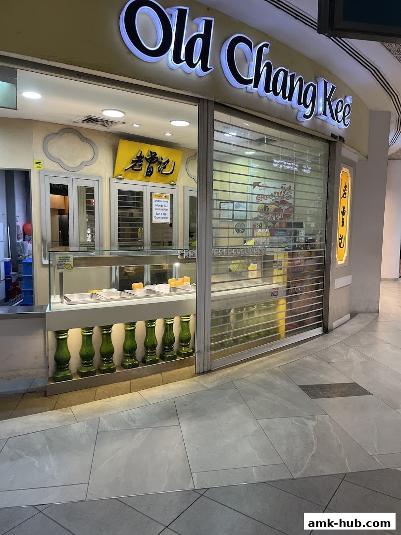 The Old Chang Kee shop front with its illuminated sign and display window.