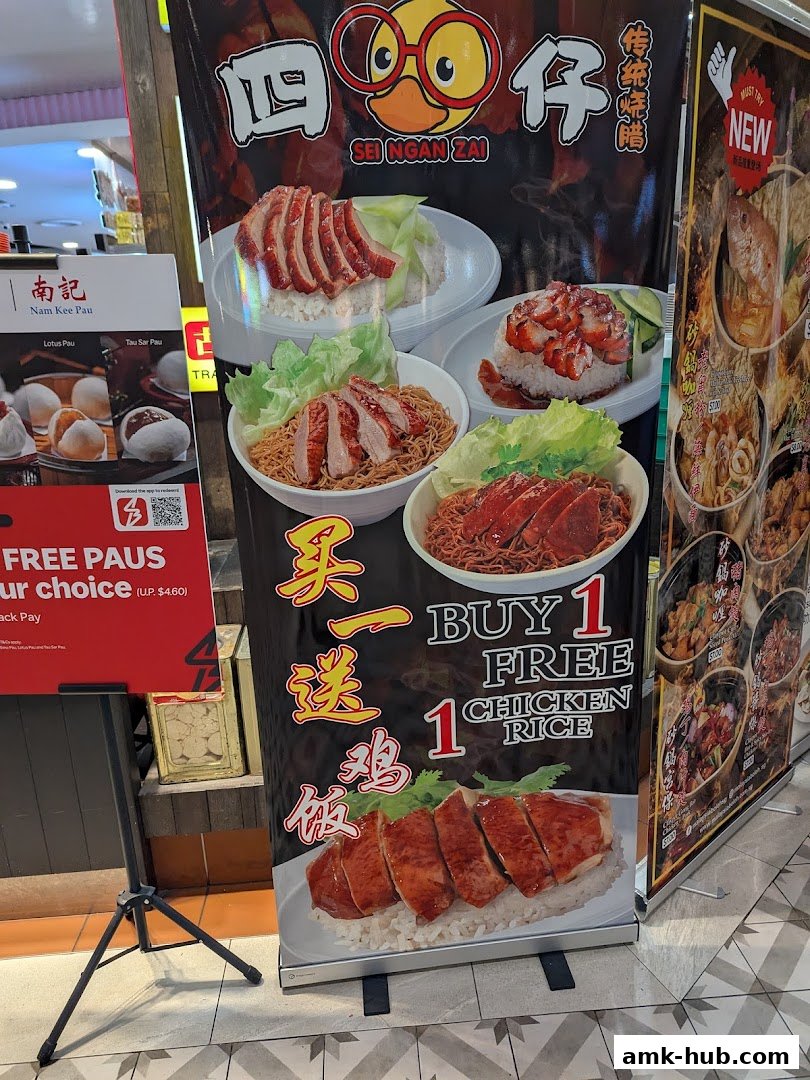 A promotional banner for Sei Ngan Zai featuring roast meats and a buy one get one free chicken rice offer.