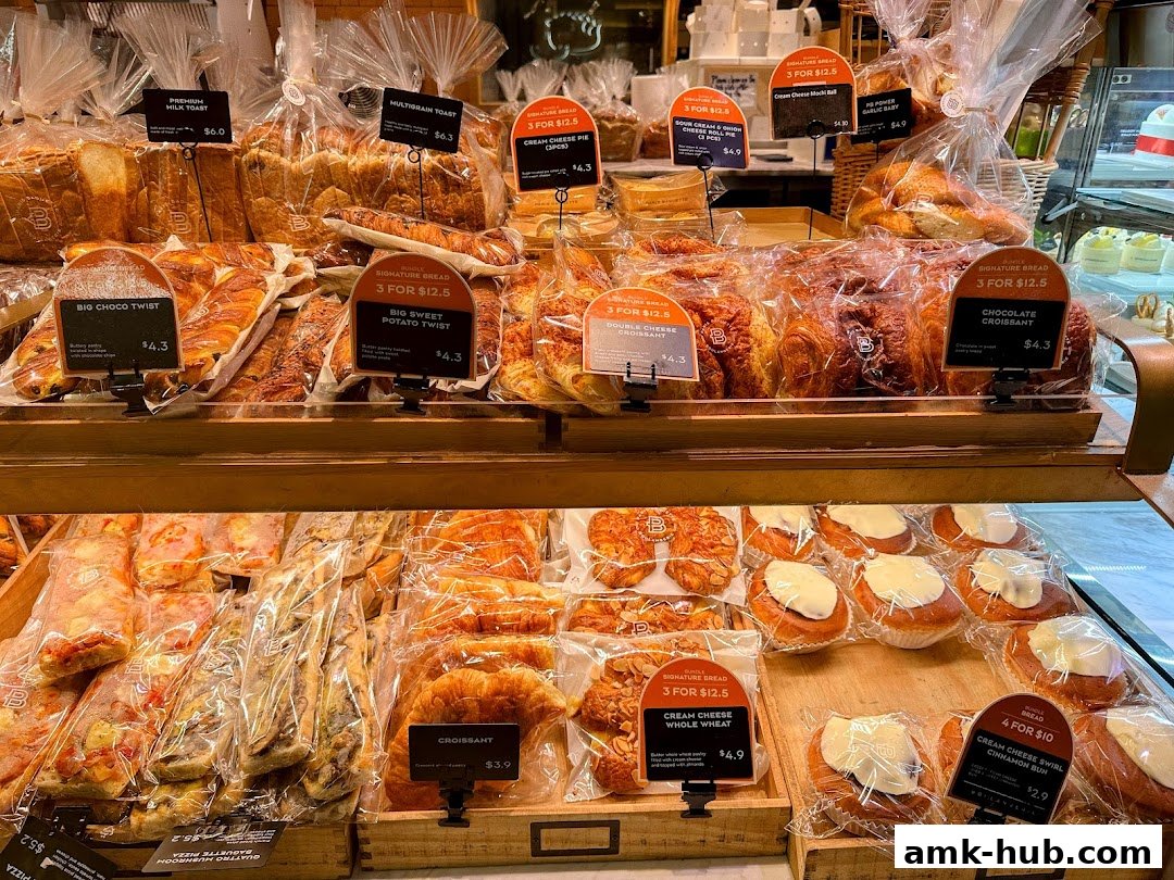 A display of freshly baked breads, pastries, and buns at Paris Baguette.