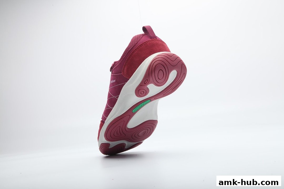 A close-up studio shot of a stylish, maroon walking shoe with a white sole.