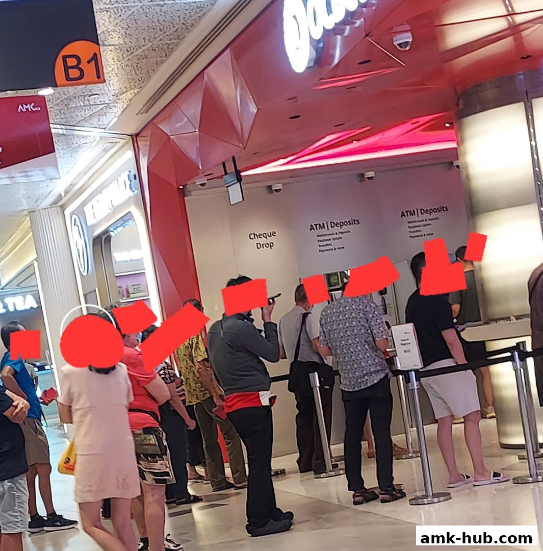 People queuing at OCBC Bank for ATM deposits and cheque drop services.