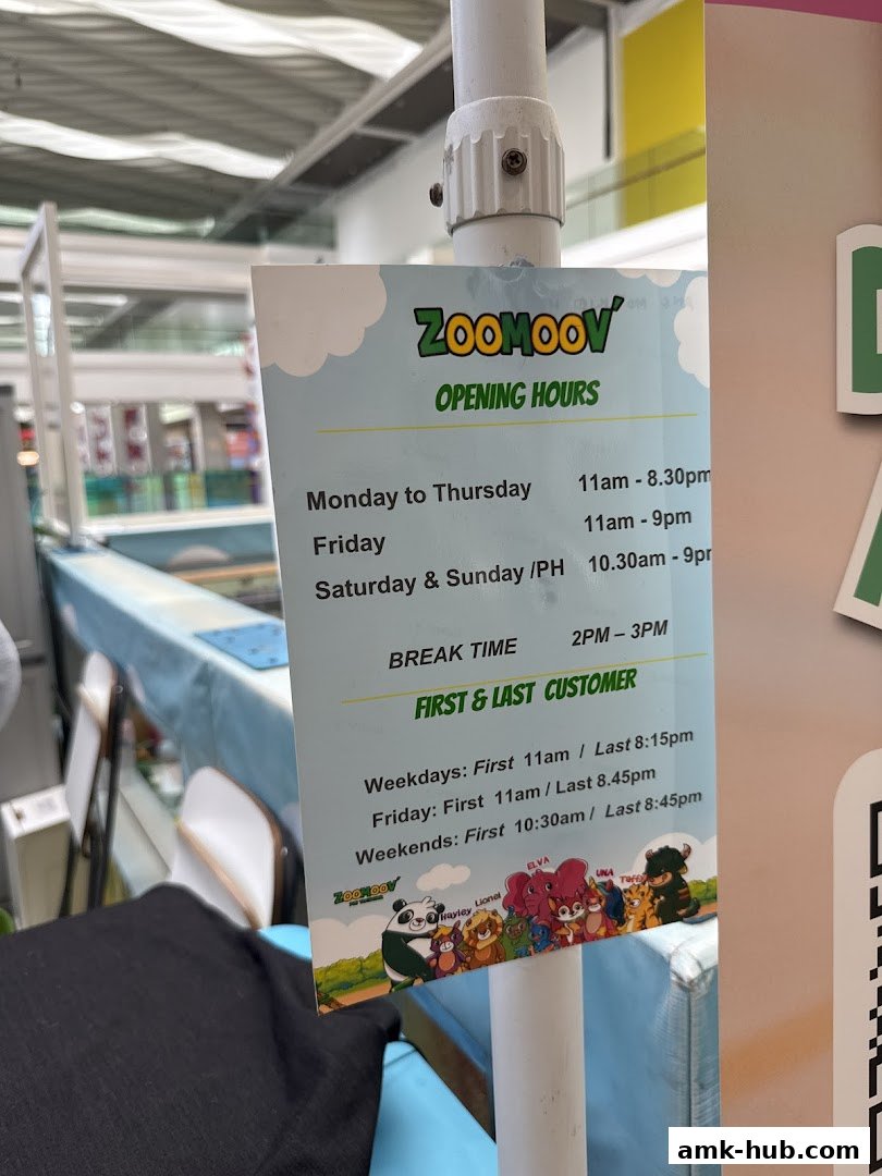 A sign displaying the opening hours and first/last customer times for Zoomoov.