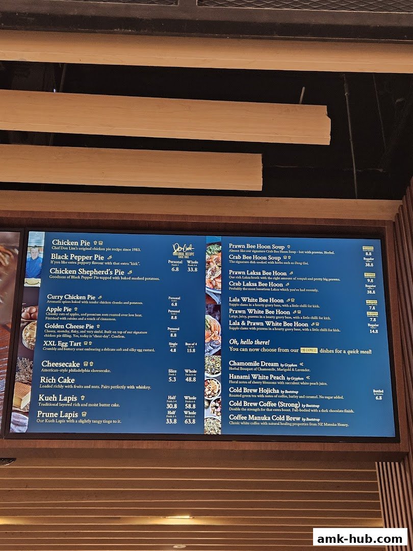 A digital menu board displaying various pies, cakes, and beverages with prices.