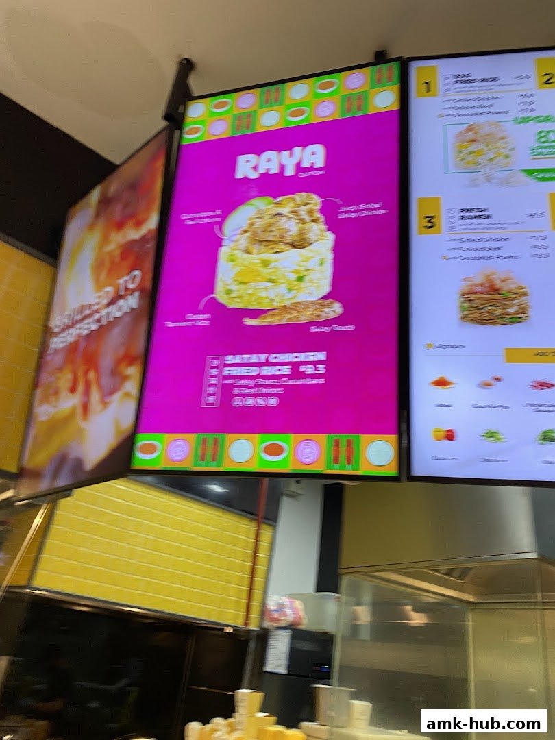 Digital menu boards displaying food items and prices at WOK HEY.