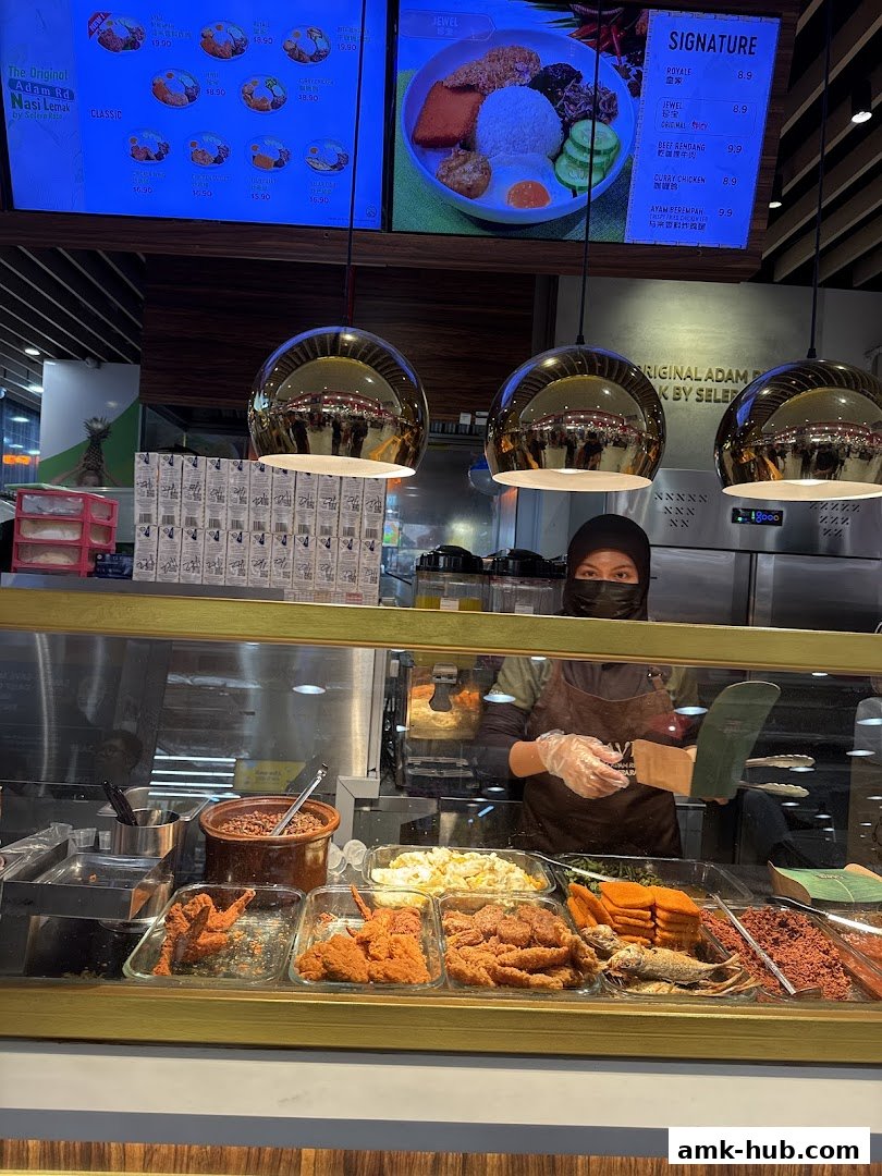 A display of Nasi Lemak dishes and ingredients at a food stall.
