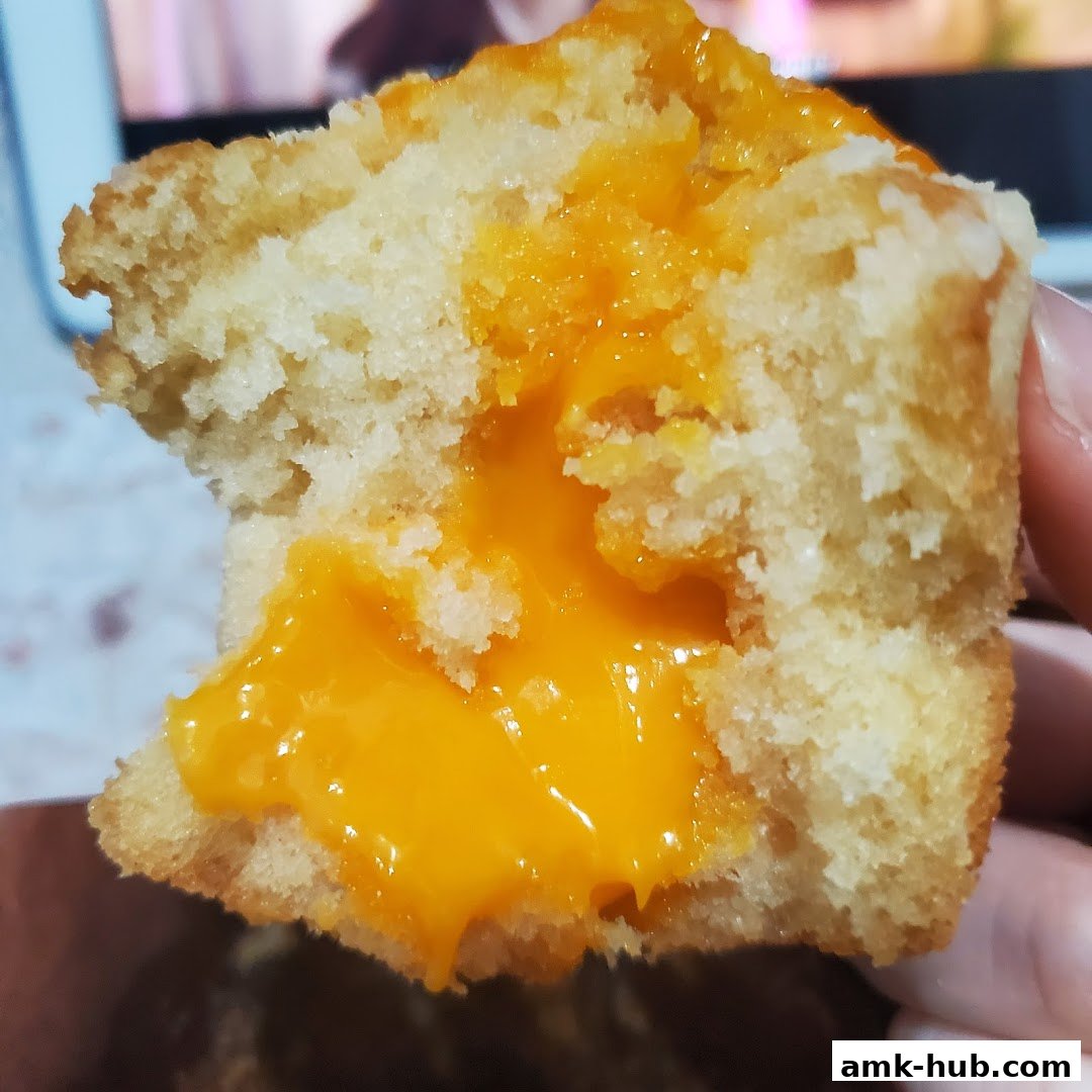A close-up shot of a delicious-looking pastry with a rich, gooey orange filling.