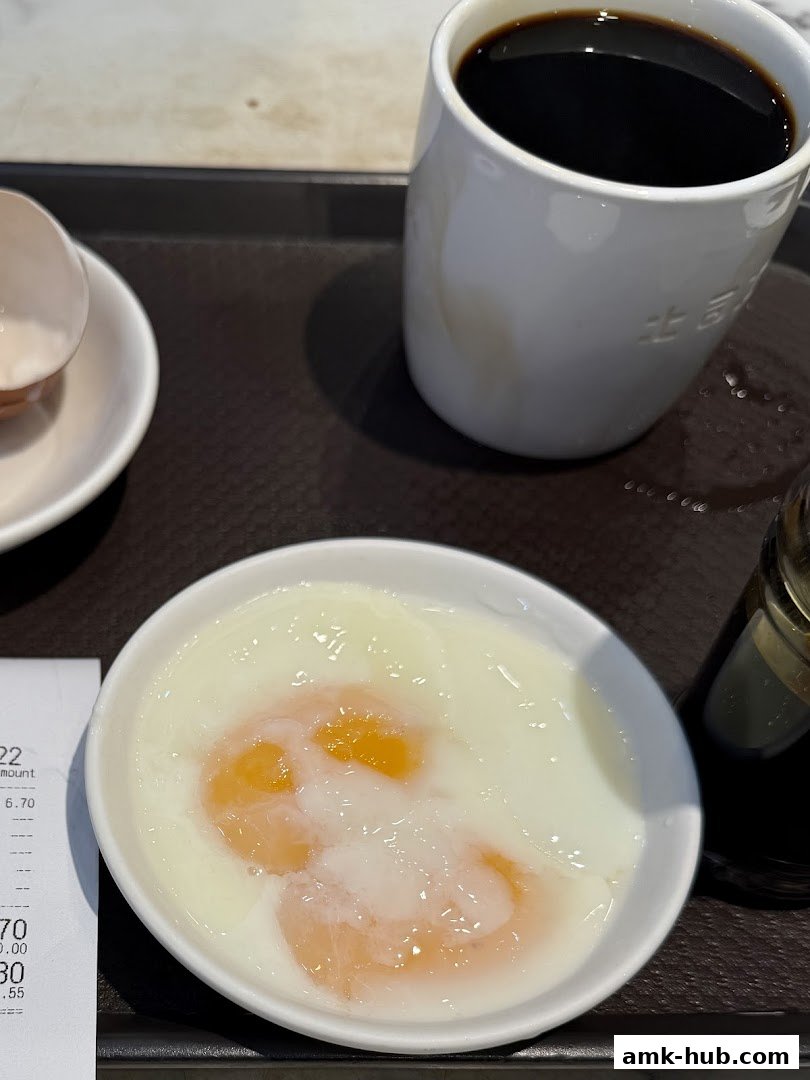 A close-up of soft-boiled eggs and a cup of coffee on a tray.